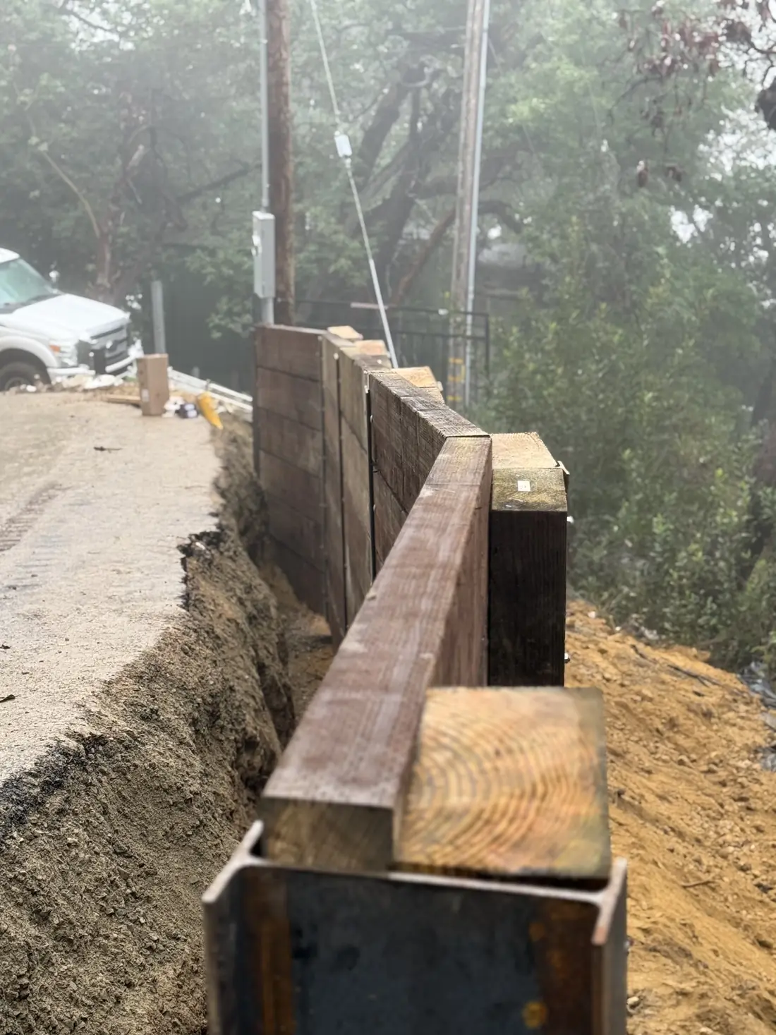 Finished wood retaining wall with a heavy timber cap
