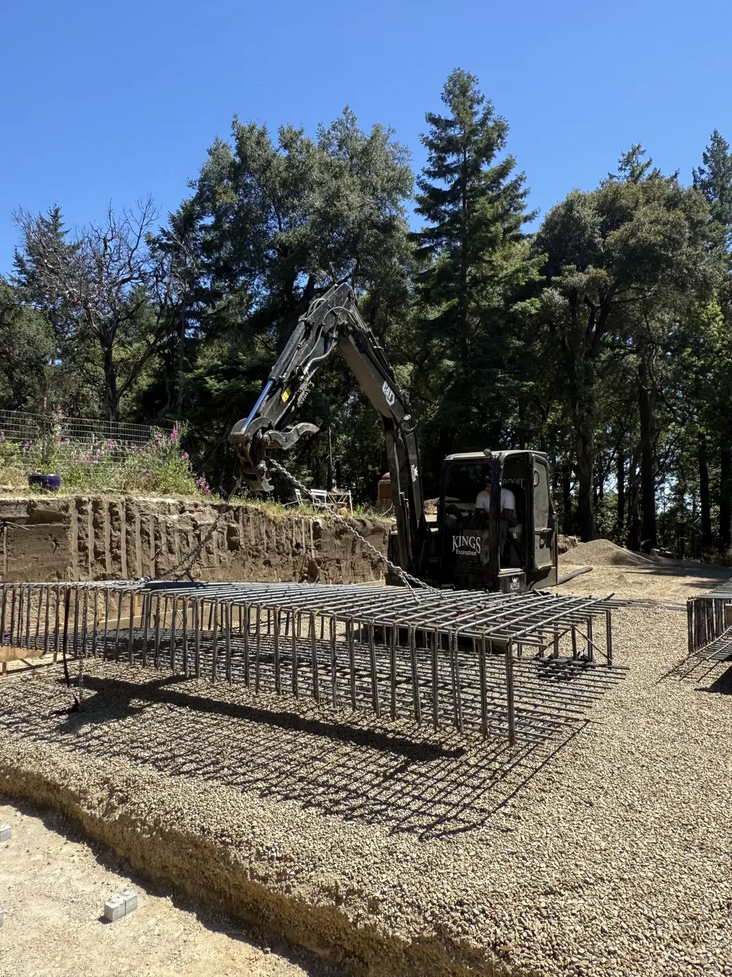 Rebar and formwork set for a concrete foundation with a Kings excavator