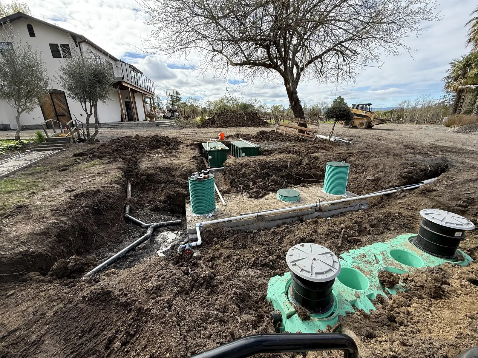 Complex multi tank septic system with risers and lines installed at a residential property